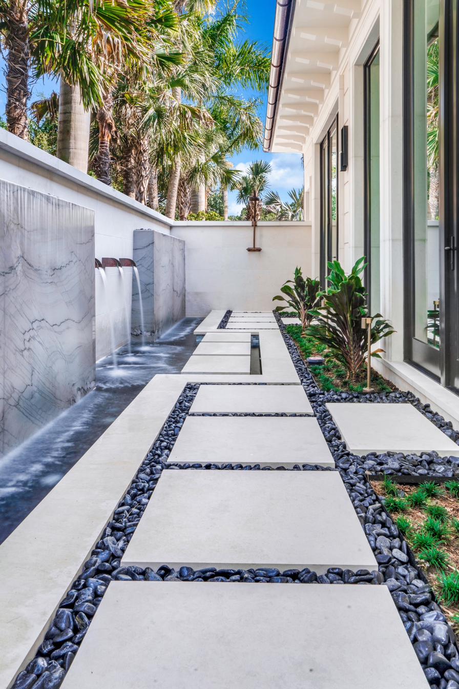 Marble water feature and stone path at a private Old Palm residence